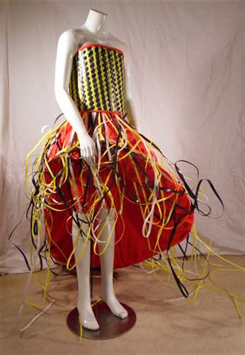 Off the Box by Greg Dugdale, Age 18. Materials: recycled plastic box ties, grommets, tie-dyed muslin, hoop skirt