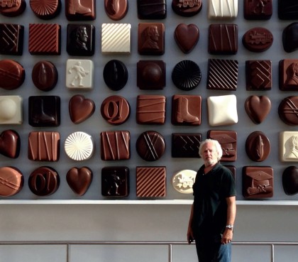 Donald Lipski in front of his installation The Candy Box, 2013. Plastics, steel, LED lighting. 21’ x 13’ x 14”. For the new Pinnacle Bank Arena in the Haymarket Section of Lincoln, NE, Lipski created a giant box of chocolates, paying homage to Lincoln's history as a center of chocolate manufacturing. Many of the chocolates have shapes and images that relate to symbols of Lincoln, past and present. (Photo: John Grant)