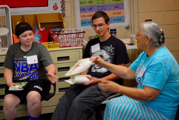 Denise Lajimodiere (right) leads students Jeryn (left) and Rick in memoir writing