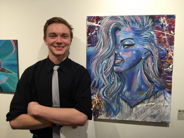 Nathan Maliscke with his painting, “Don’t Be Like the Rest of Them”